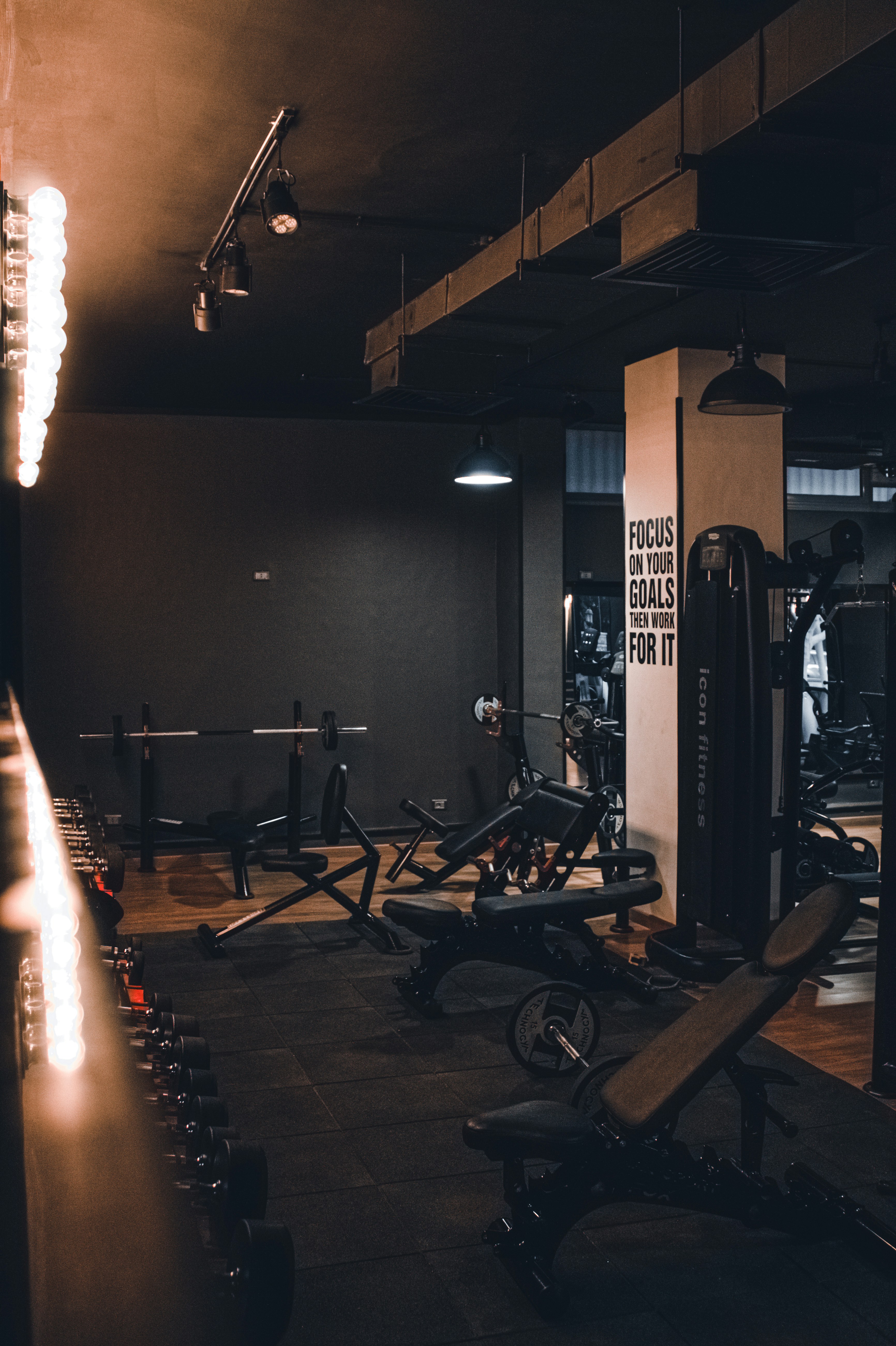 A quiet strength-training gym with benches, weights, and machines